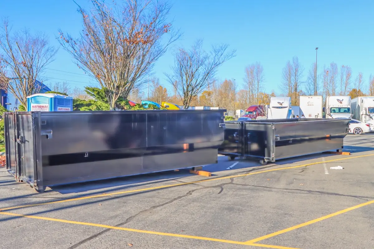 Professional dumpster rental service with roll-off container on residential driveway in Swainsboro